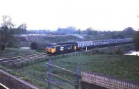 An eastbound express on the west of England main line in 1985 behind 50037 <i>Illustrious</i> about to pass under the Salisbury line.  <br><br>[John McIntyre //1985]