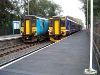 Newcastle - Stranraer and Carlisle - Newcastle trains cross at Bardon Mill in October 2006.<br><br>[John McIntyre /10/2006]