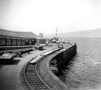 Wemyss Bay Pier. This siding held tank wagons for refuelling ferries, it remained long after all the goods lines were lifted. Note the lifeboat behind the buffers. The white roofed building at the end was a signal box operating four semaphore berth indicators on the post above it.<br><br>[John Gray /09/1967]