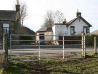 Looking west over the old level crossing towards Walkerburn station in 2007. The canopy area has been converted into an extension to the station building with another built over the trackbed. The former station masters house stands on the left.<br><br>[John Furnevel 19/02/2007]