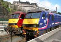 Sleeper locomotives stabled in the short bay at the east end of Waverley on 3 March 2007, with 90024 in First ScotRail/EWS Sleeper livery and 90039 in standard EWS colours.<br><br>[John Furnevel 03/03/2007]