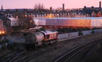 Against a backdrop of the sun setting over Aberdeen a 66 sits in the loop on the Waterloo branch at Kittybrewster. The main line is to the right.<br><br>[Ewan Crawford 27/01/2007]