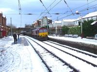 Hunterston bound 66084 passing through Johnstone Station.<br><br>[Graham Morgan 18/01/2007]