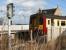 The driver of a stopping train activates the half-barrier level crossing west of the station prior to leaving Kirknewton for Glasgow Central on 5 March 2007.<br><br>[John Furnevel 5/03/2007]