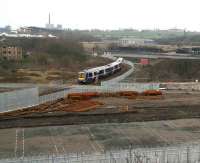 A Queen Street train off the Cumbernauld line heads along the south side of the Cowlairs triangle on 26 March 2007. It has just cleared the level crossing controlling access to the works site for the new MDU and signalling centre.   <br><br>[John Furnevel 26/03/2007]