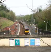 A Newton train arriving at Kirkhill on 15 April 2007. View from the road bridge over the broad mezzanine level where the station building once stood. [See image 8051]<br><br>[John Furnevel 15/04/2007]