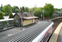 View over Busby station on 6 May 2007 towards the former station building, now the <I>Shanghai Express</I> takeaway. A train for Glasgow Central is just leaving the northbound platform.<br><br>[John Furnevel 06/05/2007]