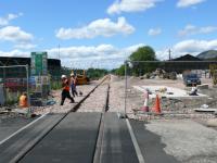 Looking west from the rubber surfaced level crossing. Workers are running cables from the conduit on left of track to under the base of a signal relay cabinet.<br><br>[Brian Forbes 21/05/2007]