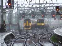 A Class 156 and Class 314 approaching Glasgow Central in the driving rain.<br><br>[Graham Morgan 19/05/2007]