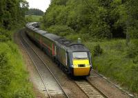 The 0955 Aberdeen - Kings Cross HST descending Donibristle Bank east of Dalgety Bay on 7 June. The former branch to the nearby RN Air Station ran through the trees in the right background.<br><br>[Bill Roberton 7/06/2007]