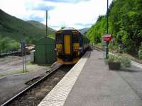 Glasgow Queen Street train leaving Arrochar and Tarbet on 28 May passing the timber loading area on the left.<br><br>[John McIntyre 28/05/2007]