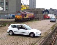 67011 stabled at the west end of Guild Street yard in June 2007 with Market Street and the docks beyond. No idea what happened to the car!<br><br>[Mick Golightly /06/2007]