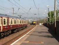 An Ayr - Glasgow train pulls out of Prestwick Town as a southbound train approaches the station in May 2007.<br><br>[John Furnevel 03/05/2007]