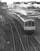 A diverted Edinburgh - North Berwick DMU at Lochend South Junction in 1987. The trackbed heading off to the right ran to Leith Central.<br><br>[Bill Roberton //1987]
