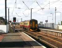 Train from Glasgow Central runs over the crossing into Kirknewton station in March 2007 on its journey to Waverley. <br><br>[John Furnevel 05/03/2007]