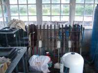 Inside the signal box,surrounded by clutter,the lever frame and levers.<br><br>[John Gray 20/07/2007]