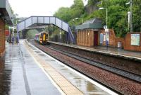 A cloudburst over Falkirk High station in May 2005 as a 158 approaches from the Edinburgh direction.<br><br>[John Furnevel 25/05/2005]