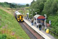 Looking west towards Bathgate as a train for Waverley pulls into the cramped station at Livingston North on 10 August 2007.<br><br>[John Furnevel 10/08/2007]