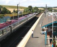 Edinburgh bound Voyager leaves Alnmouth. The former shed and platform for the Alnwick branch stood on the other side of the wooden fence. <br><br>[John Furnevel 16/08/2007]