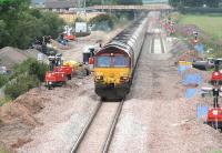A southbound coal train runs south through Dornock on 3 August past the junction for the munitions sidings at Eastriggs with engineering work in progress in connection with the redoubling of the Gretna - Annan section.<br><br>[John Furnevel 03/08/2007]