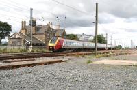 View north west across the site of Belford station on 16 August 2007 with a Voyager passing en route to Waverley. The station closed to passengers in January 1968. [See image 16269]<br><br>[John Furnevel 16/08/2007]