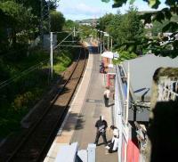Passengers wait for a delayed Glasgow train at Branchton on 29 July 2007. View west towards Wemyss Bay.<br><br>[John Furnevel 29/07/2007]