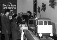 <I>'No,no madam, they'll be much bigger than this one...'</I> Rail staff publicise the forthcoming Glasgow-London electric services [see image 29515] at an exhibition at Glasgow Central station in the Spring of 1974.<br><br>[John McIntyre //1974]