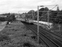 A Glasgow bound service off the West Highland Line passes through Cardross in July 1986. <br><br>[John McIntyre 15/07/1986]