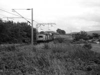 Class 37 with a train for the West Highland Line approaching Cardross in July 1986.<br><br>[John McIntyre 15/07/1986]