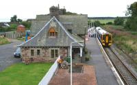 Rush hour at Golspie on 30 August 2007 as the 0923 to the far north pulls into the platform. (The group had arrived at the station on a tour bus 10 minutes earlier.)<br><br>[John Furnevel 30/08/2007]