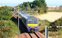 The 10.37 Waverley - North Berwick service, having left the ECML at Drem Junction on 2 October 2007, approaches the former Dirleton station, now mostly hidden by trees and in use as a holiday bed and breakfast establishment. <br><br>[John Furnevel 02/10/2007]