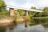 View north east across the Endrick Water towards Balfron on 11 October, showing the stone piers of the former Drymen Viaduct and the water pipeline, with walkway above, that now spans the river.  <br><br>[John Furnevel 11/10/2007]
