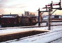 A low Winter sun illuminates the snow covered south end of Aberdeen station in November 1973 as D3877 undertakes shunting duties in the adjacent Guild Street yard.<br><br>[John McIntyre 21/11/1973]