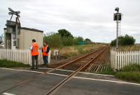 Maintenance and testing of warning lights and audible alarm being carried out at Bridge Street open level crossing, Halkirk, on 28 August 2007. View is northeast towards Georgemas Junction over the site of the former Halkirk station (closed 1960) which stood just beyond the crossing. Three occupants of a car tragically died as a result of a collision with a train on this crossing in September 2009. <br><br>[John Furnevel 28/08/2007]