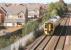 Scene just west of Gartcosh station on 25 September showing part of the current housing boom in the area. The train is a Falkirk Grahamston - Glasgow Queen Street service. <br><br>[John Furnevel 25/09/2007]