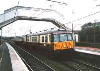 303021 forming a Partick - Carstairs (Mon-Fri only) service stops at Carluke on 30 March 1998. <br><br>[David Panton 30/03/1998]