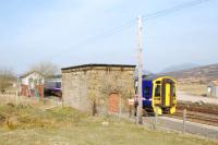 Northbound service passes the old watertank and the signalbox at the north end of Dalwhinnie.<br><br>[Ewan Crawford 14/04/2007]