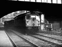A short freight for Guild Street yard hauled by a class 26 rumbles south under Union Street Bridge and past Aberdeen North box in February 1973.<br><br>[John McIntyre /02/1973]