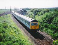 Looking towards Drem Junction in June 1995 as 305 502 leaves the ECML and runs onto the branch with a service for North Berwick.<br><br>[David Panton /06/1995]