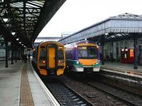 Local trains pass in Stirling station. On the left 158705 from Edinburgh to Dunblane while 170422 is on a Dunblane to Glasgow service. <br><br>[Brian Forbes 27/12/2007]