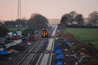 Sprinter heads into the sunset at Eastriggs. New line to right and MOD depot to left.<br><br>[Ewan Crawford 03/01/2008]