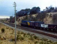 A class 26 picks up the freight from the goods yard at Maud on the return leg of the daily Craiginches - Fraserburgh goods run in the spring of 1979.<br><br>[John Williamson /03/1979]