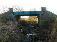 A last look at the A950 road over-bridge at Brucklay before demolition, looking south from the former station towards Maud Junction. Until recently this bridge was almost totally obscured at ground level by trees and vegetation.<br><br>[John Williamson 19/01/2008]