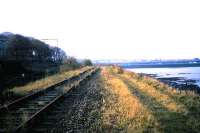View looking west from Challenger Lodge along the embankment running between Lower Granton Road and the Firth of Forth towards Granton Harbour in November 1985 with track still in place.<br><br>[David Panton /11/1985]