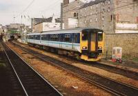 150 258 leaves Haymarket station for Bathgate in June 1994. Photographed from a passing train.<br><br>[David Panton /06/1994]