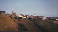 View of Fraserburgh station and yard from Links Road bridge in the summer of 1972. At this time the basic integrity and general condition of the abandoned site was still fairly good and it is not hard to imagine how it had been 7 or 8 years earlier. However the next couple of years were not so kind, and the building of an adventure playground on the site of the old turntable only accelerated the inevitable vandalism, which up to this point had been negligible.<br><br>[John Williamson //1972]