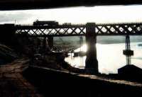 40192, with its boiler water tanks removed, is silhouetted crossing the King Edward Bridge in November 1980. Photographed looking west along the Gateshead bank of the Tyne with Redheugh Bridge visible in the background.<br><br>[Colin Alexander 01/11/1980]