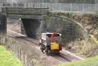A machine that appears to eat trees heading back to the yard at Kincardine after clearance work on 28 February. The yard is reached via a reversal along the line which can be seen on the other side of the bridge.<br><br>[John Furnevel 28/02/2008]