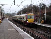 A train for Dalmuir via Motherwell formed by 334 013 stands at Airbles on 23 February.<br><br>[David Panton 23/02/2008]
