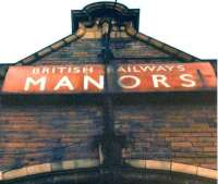 British Railways enamel name board in NER tangerine below the clock tower at the old Manors North station, Newcastle, on 14 February 1982. [See image 13227]<br><br>[Colin Alexander 14/02/1982]